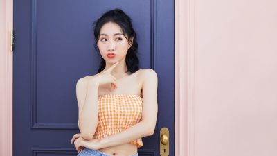 Woman in checkered top posing playfully